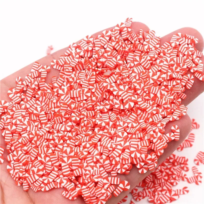 A handful of small red and white polymer clay slices for DIY crafts