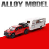 A red truck model is shown next to a white RV camper truck model on a red surface.