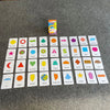 A collection of colorful learning flash cards featuring various shapes and geometric figures arranged on a gray surface.
