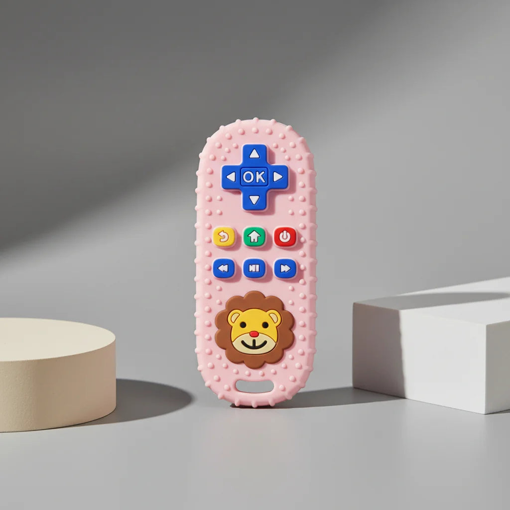 A pink lion-shaped silicone baby teether with a remote control design featuring various buttons.