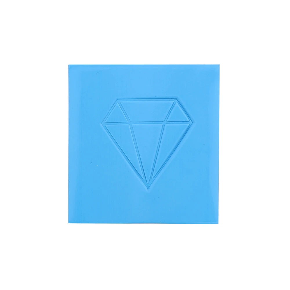 A square block of light blue diamond painting clay with a carved diamond shape on the top surface.