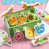 A green basket filled with various orange, yellow, and green 3D foam art paper creations featuring animal shapes like cats an