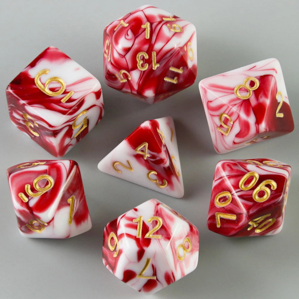 A set of red and white marbled acrylic dice showing various numbers for tabletop gaming.