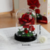 A clear glass jar filled with a miniature floral arrangement made of red building blocks on a white background.