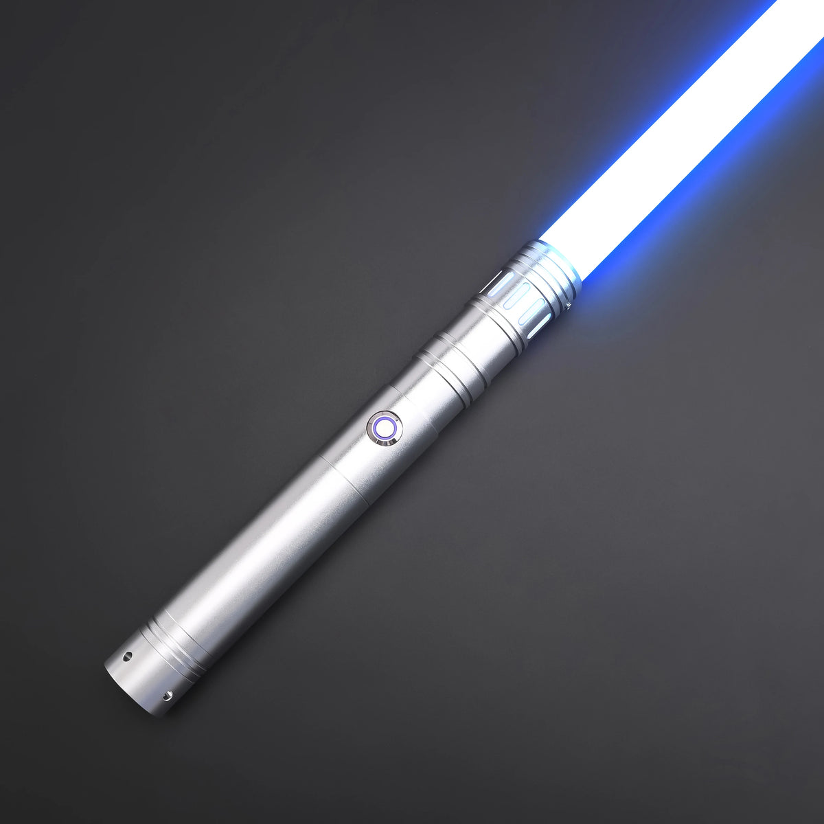 A blue lightsaber toy with a silver metal handle and glowing blade, shown diagonally against a dark gray background.