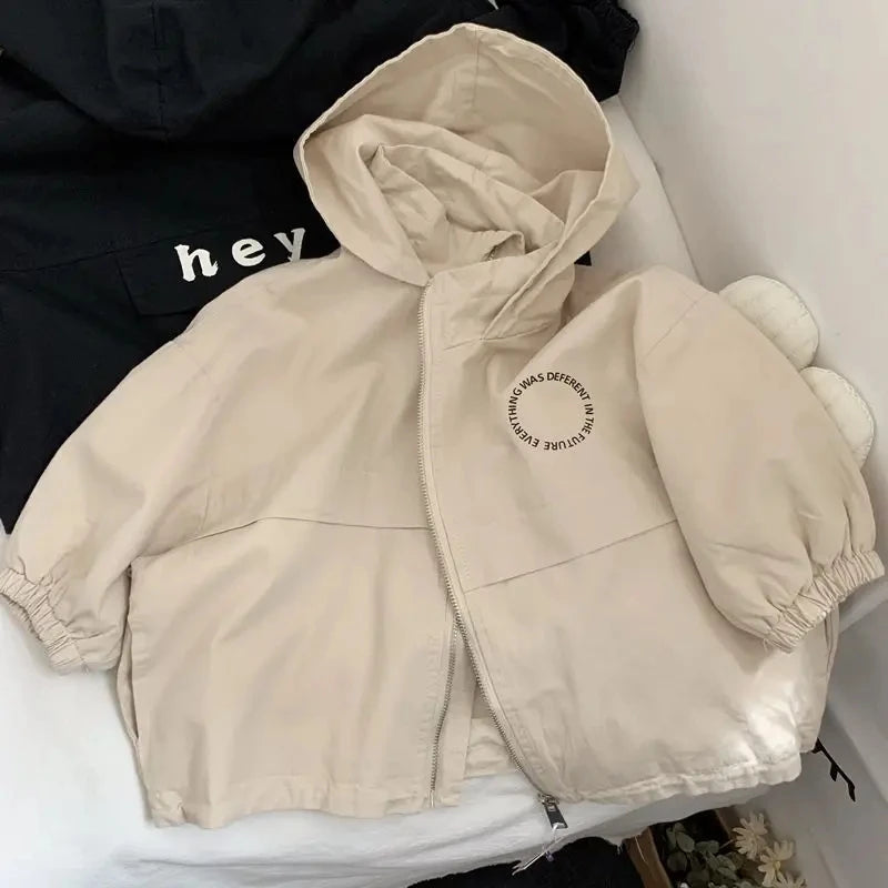A beige kids hooded zip-up jacket is displayed on a white surface.