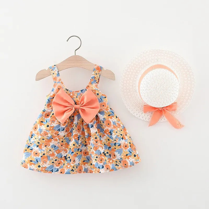 A floral print baby girl summer dress and sunhat set featuring orange bow details.