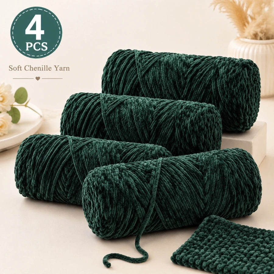 A bundle of four green soft chenille yarn strands is displayed on a white surface.