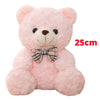 Pink teddy bear plush pillow with a plaid bow