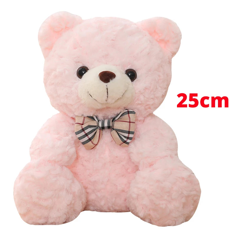 Pink teddy bear plush pillow with a plaid bow