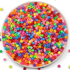 A bowl filled with a large assortment of colorful pony beads for jewelry making and crafts