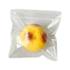 A yellow, slightly bruised apple is visible inside a clear plastic bag.
