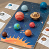 A wooden solar system puzzle featuring eight planets, including Mercury and Mars, set against a dark blue background.