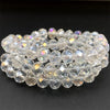 A stack of clear, faceted crystal beads used for jewelry making.