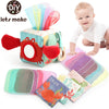 A colorful tissue box toy featuring an ocean theme with fabric inserts and a cloth book for babies.
