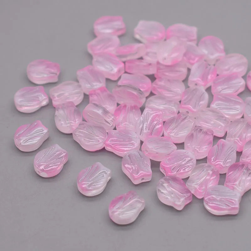 A pile of pink, translucent glass beads shaped like tulip flowers.