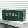 A dark green industrial iron storage box with the MOL logo resting on a white surface.