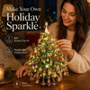 A woman is decorating a sparkling Christmas tree with beads and crystals for holiday decor.