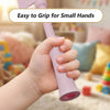 A child's hand is gripping a pink 3D printed magic wand credit card holder.