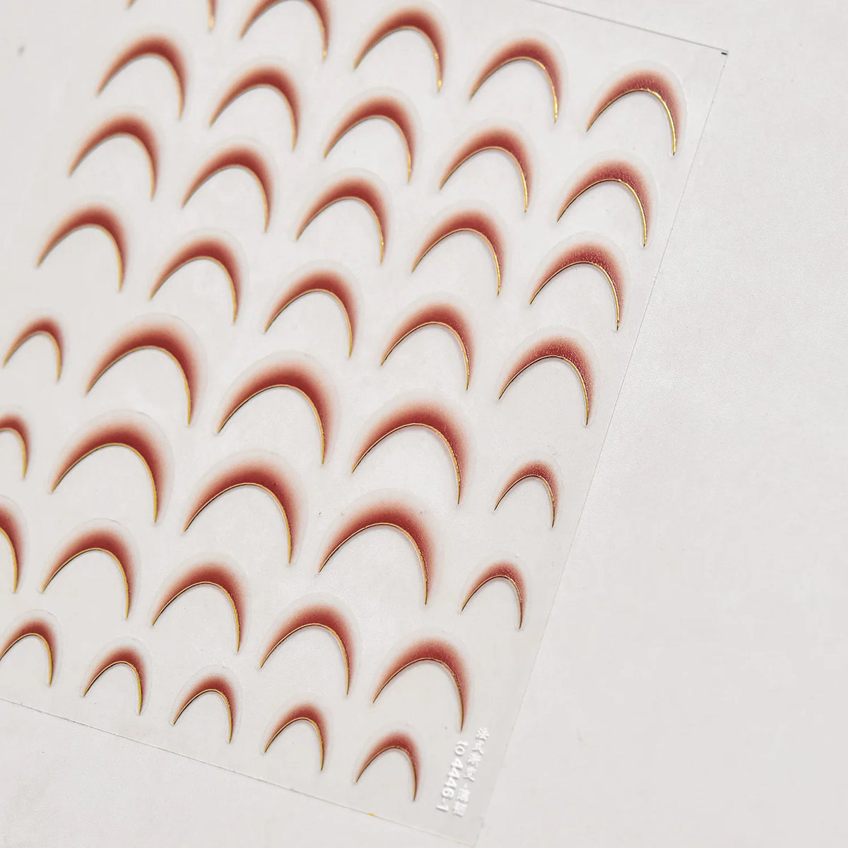 A sheet of 5D Bronzing Gothic Nail Art stickers showing various curved nail designs.