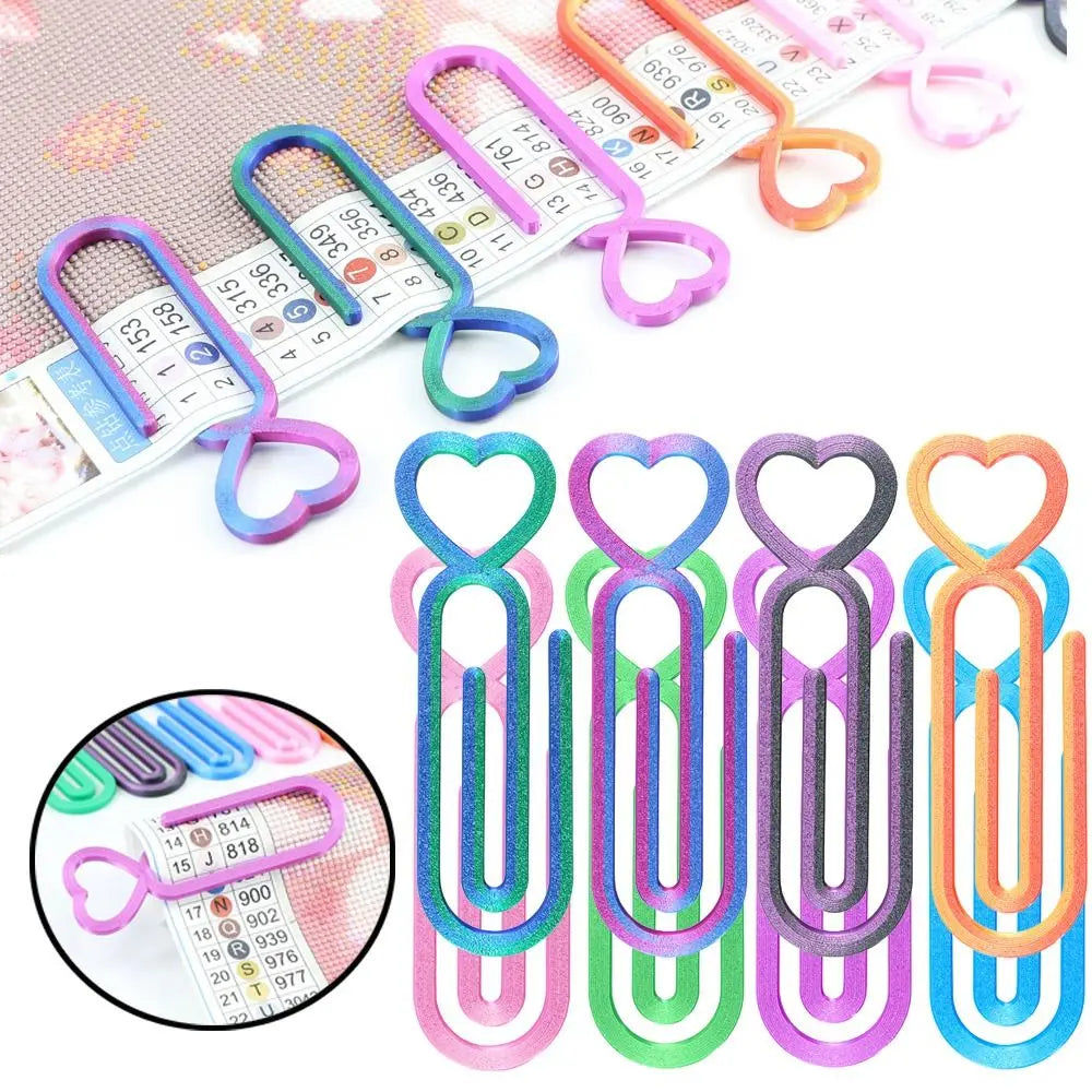 A collection of heart-shaped canvas clips in various colors and shades for diamond painting and cross stitch projects