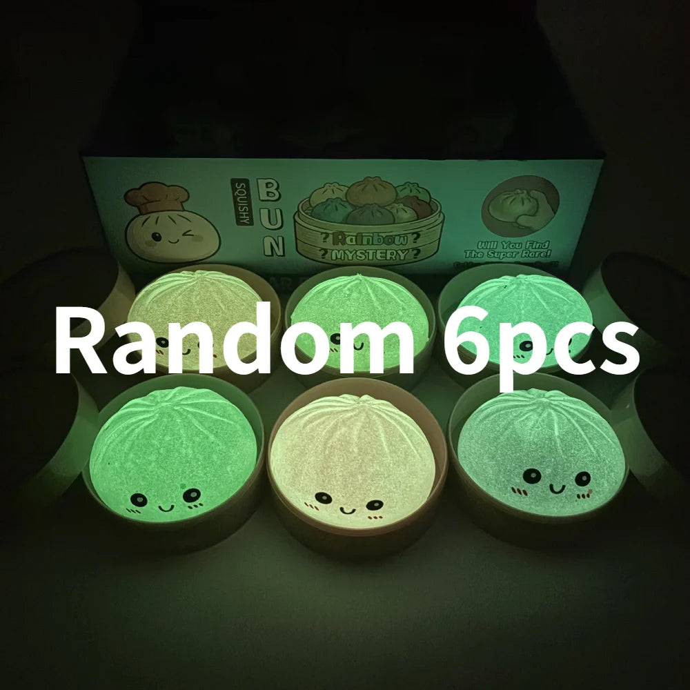 A collection of six glowing green soft sensory squishy dumpling toys displayed in a box.