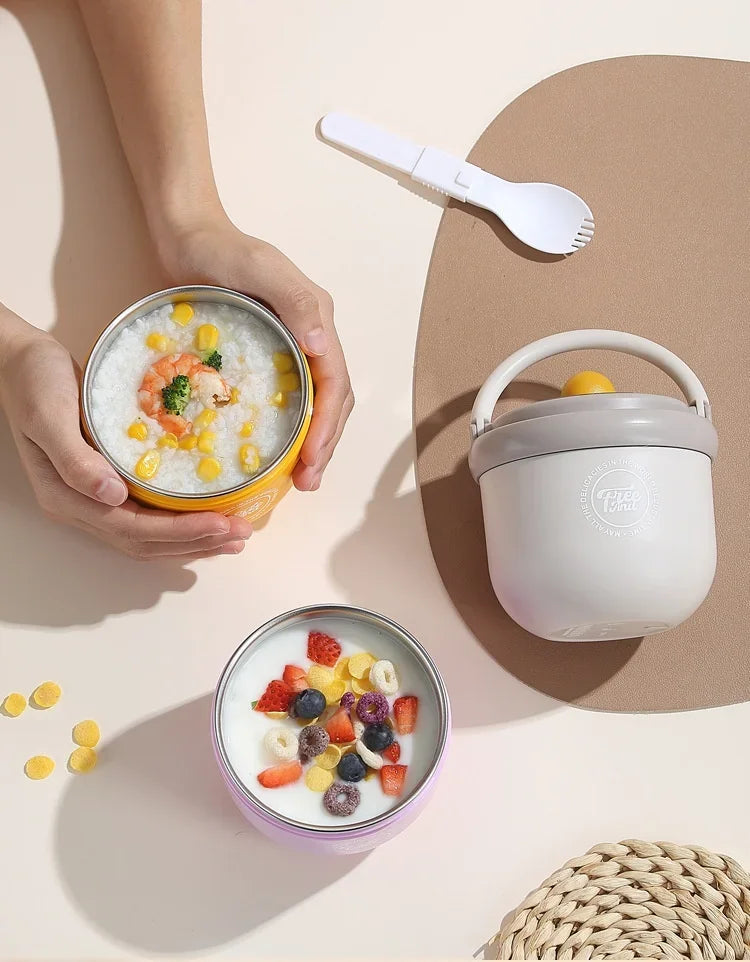 A hand holds a yellow bowl of breakfast cereal and a white spoon next to a gray insulated stainless steel cup with a lid.