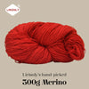 A ball of bright red Merino wool yarn labeled as Lirisnly's hand-picked 300g Merino.