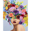A woman's face is adorned with a vibrant, colorful floral painting, featuring various shades of red, purple, pink, and yellow