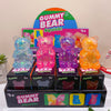 A box of Gummy Bear Squish glitter bear toys with a large graphic featuring the title and various colored bears.