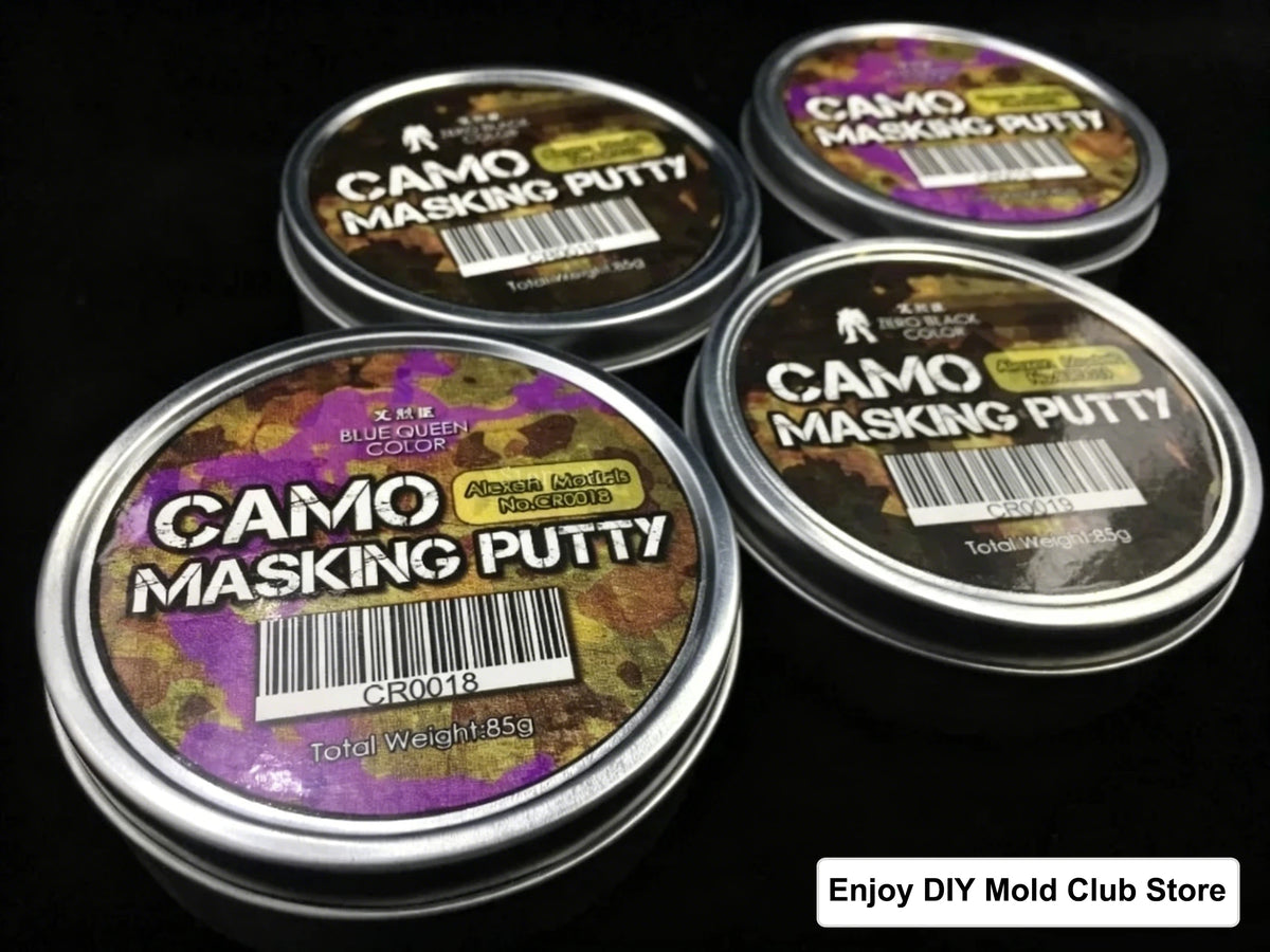 Several tins of Camo Masking Putty for model painting are displayed on a dark surface.
