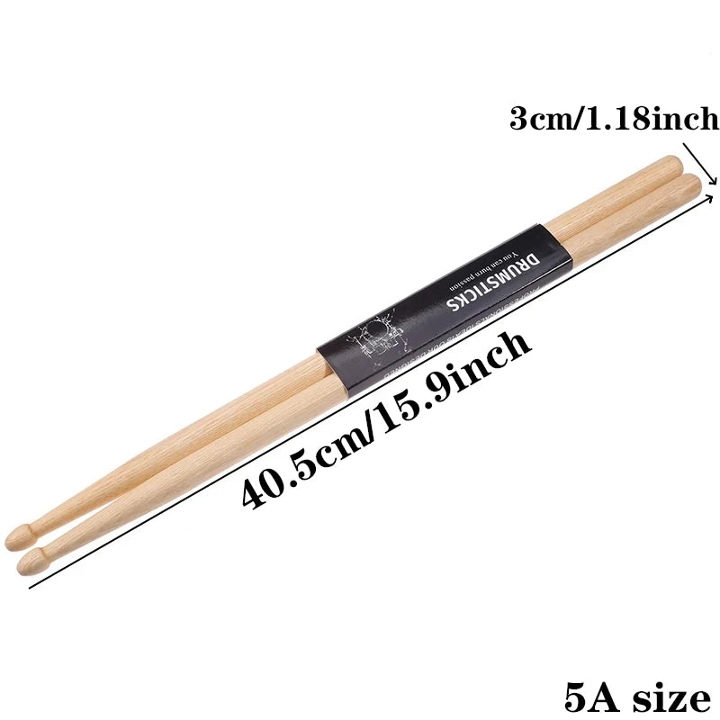 A pair of natural wood drumsticks with a black grip shown diagonally against a white background.