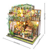 A detailed DIY miniature dollhouse puzzle kit featuring a two-story structure with greenery and decorative elements.