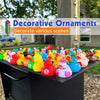 A collection of colorful mini rubber duckies party favors arranged on a dark surface.