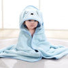 A baby wearing a light blue hooded animal bath towel with a cute face design.