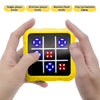 A hand holds a yellow electronic tic tac toe game board displaying various colored lights and symbols.