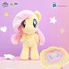 A fluffy yellow My Little Pony plush toy with pink mane and a pink saddle pendant.