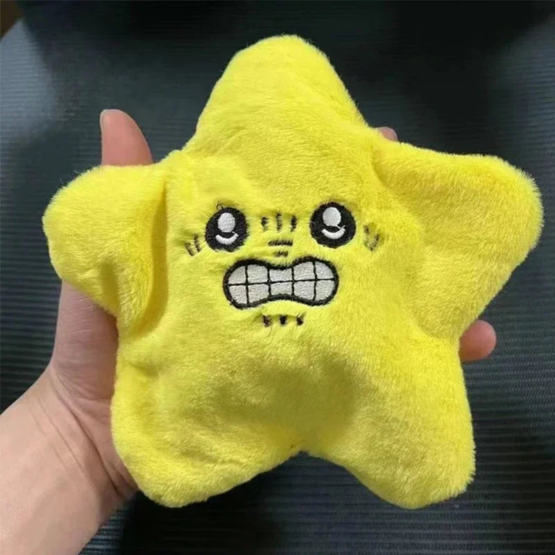 A bright yellow star-shaped plush toy with a grumpy facial expression is held in a hand.