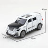 A white and black 1:36 scale die-cast metal SUV toy with opening doors and pull-back action.