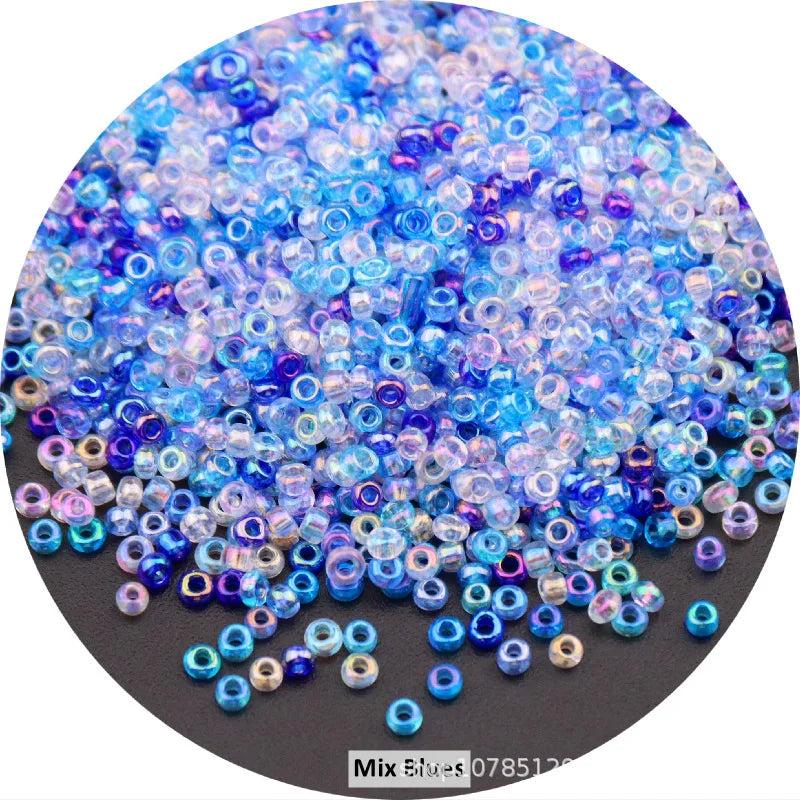 A close-up view of a mix of colorful round glass seed beads in various shades of blue and purple.