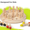 A wooden memory match stick chess game with several wooden pieces arranged on a light wood board.