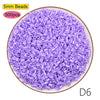 A pile of 5mm purple beads, packaged in a 500-piece kit for crafting and pixel art puzzles.