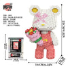 A detailed brick art set of a white bear holding a pink flower bouquet.