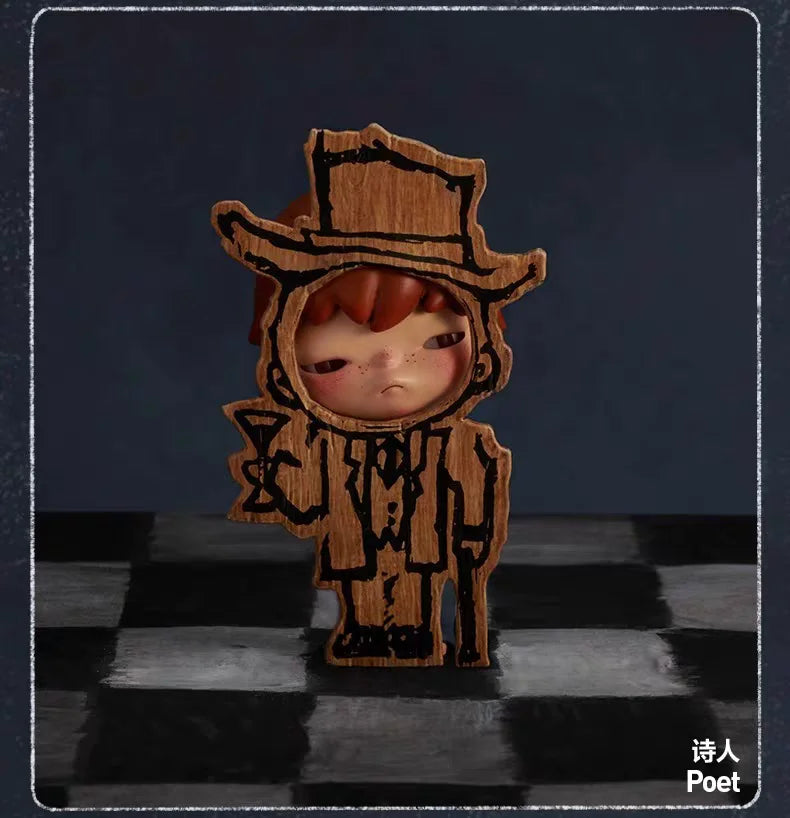 A wooden collectible figurine of a character wearing a hat and robe, set against a black and white checkered background.