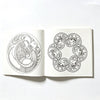 Two detailed black and white mandala designs on a page from a coloring book.
