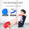 A child is using a red bouncing ball trainer with a red stick for balance and coordination exercise.