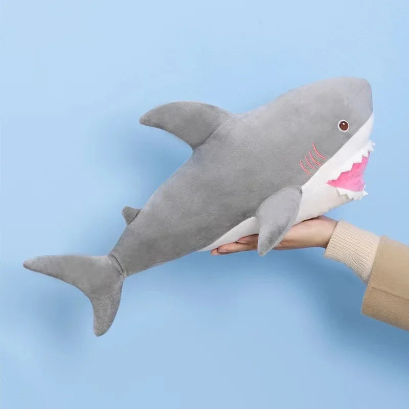 A gray and white plush stuffed animal depicting a killer whale and a great white shark.