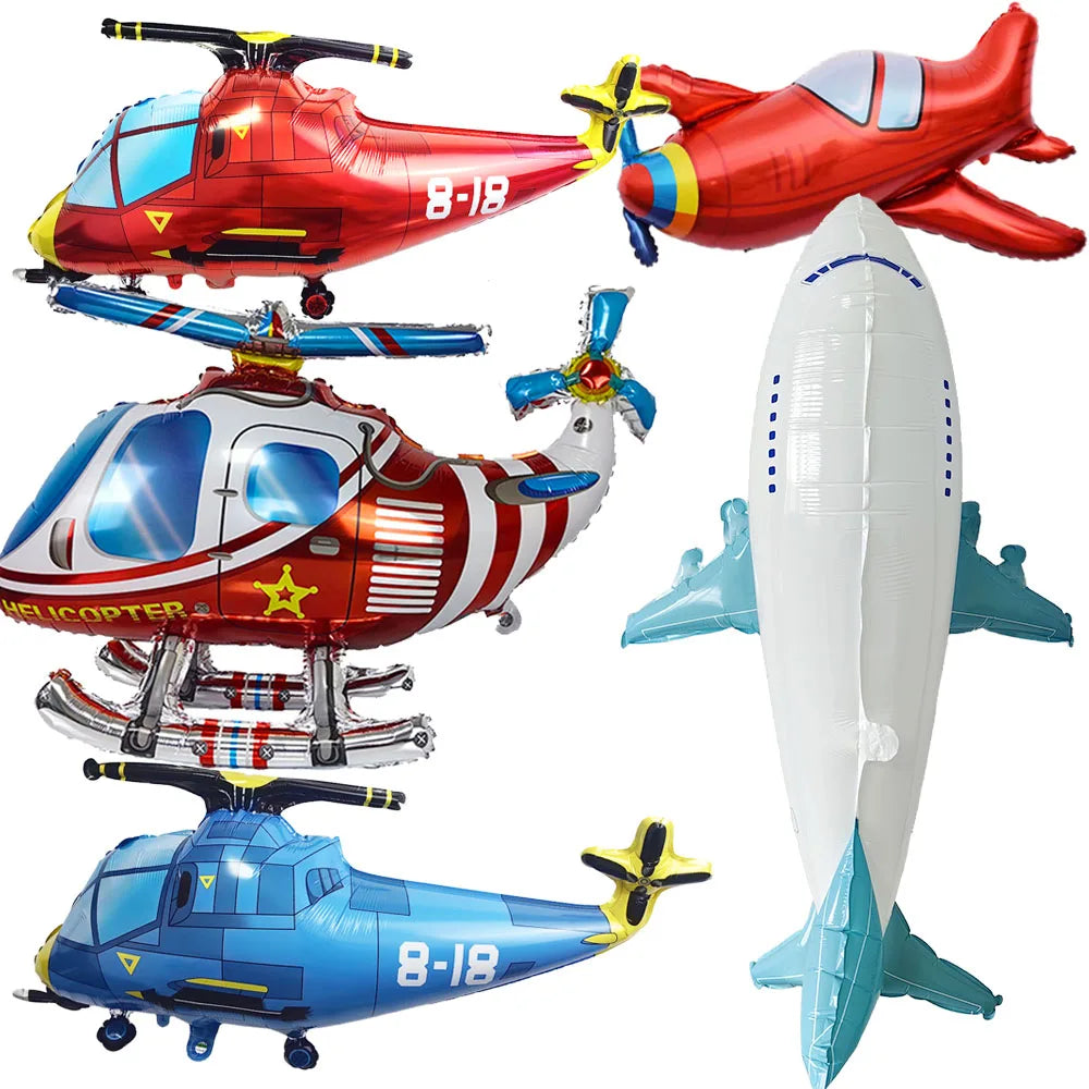 A collection of foil balloon planes and helicopters for birthday party decor.