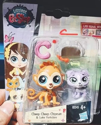 A clear plastic package containing three mini posable animal figures, including a lion, a cat, and another small animal.