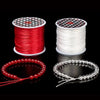 Red and white elastic beading cord spools and finished stretch bracelets